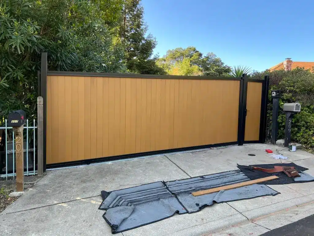 Photo Of A Tan Sliding Privacy Gate With Incorrect Gate Placement Near A Residential Curb