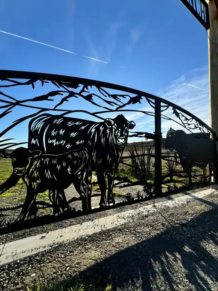 Photo A Custom Ranch Gate With Decorative Laser Cut Metal Cows Silhouetted