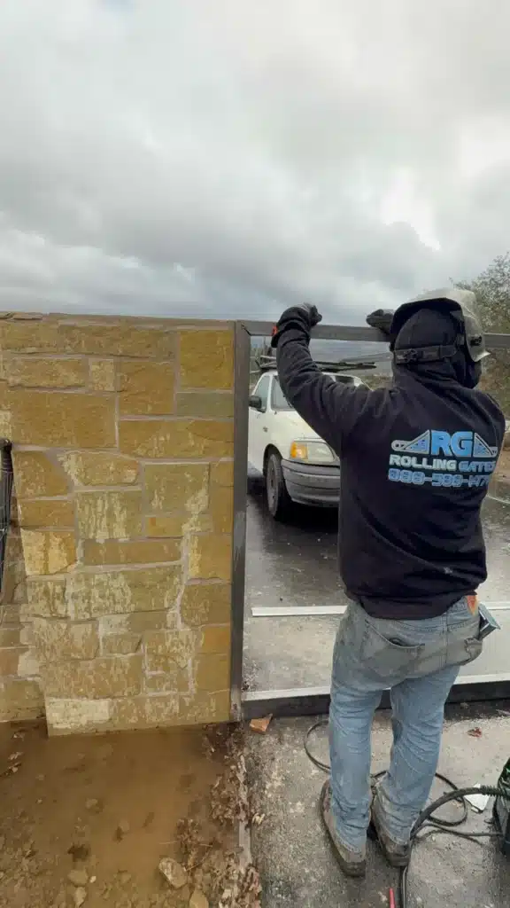 Photo A Technician Fabricating A Custom Metal Driveway Gate Frame