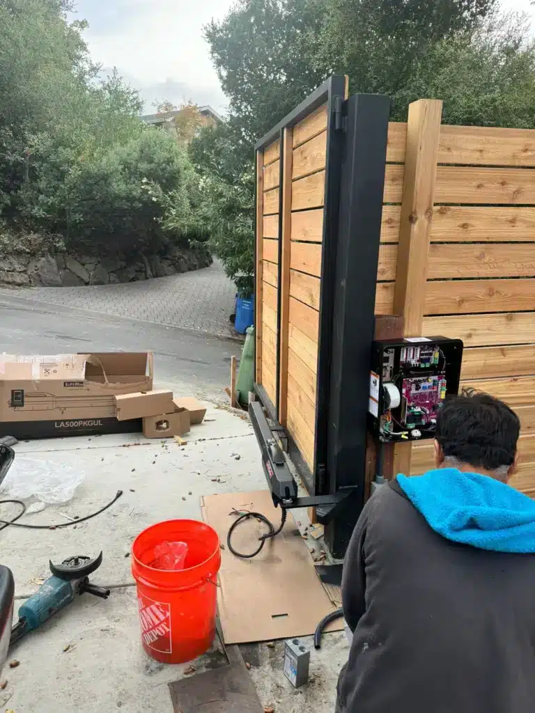 Photo Performing Automatic Gate Maintenance On An Open Control Panel Of A Wood Entry Gate
