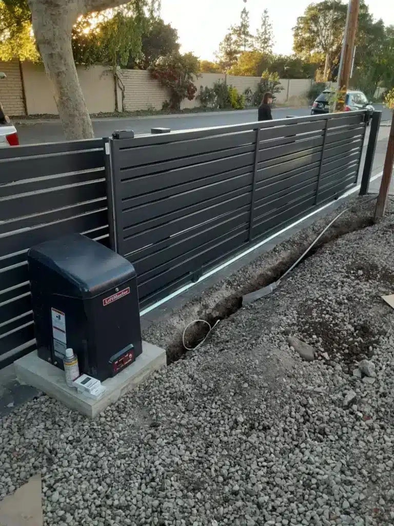 Photo Of Liftmaster Sliding Gate Motor Installed Alongside A Modern Black Fence