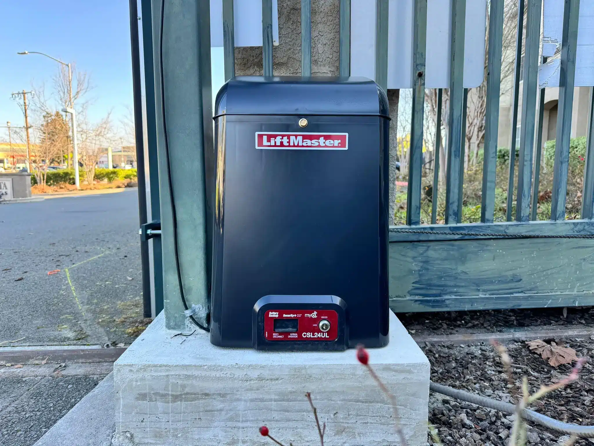 Photo Of A Black Liftmaster Csl24ul Slide Gate Operator Mounted On Concrete