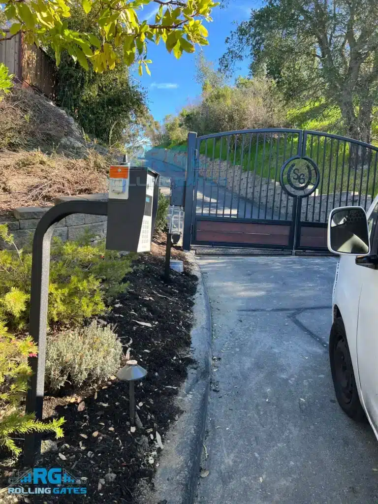 Photo Of Entry Keypad Pedestal Next To A Black Wrought Iron Driveway Gate