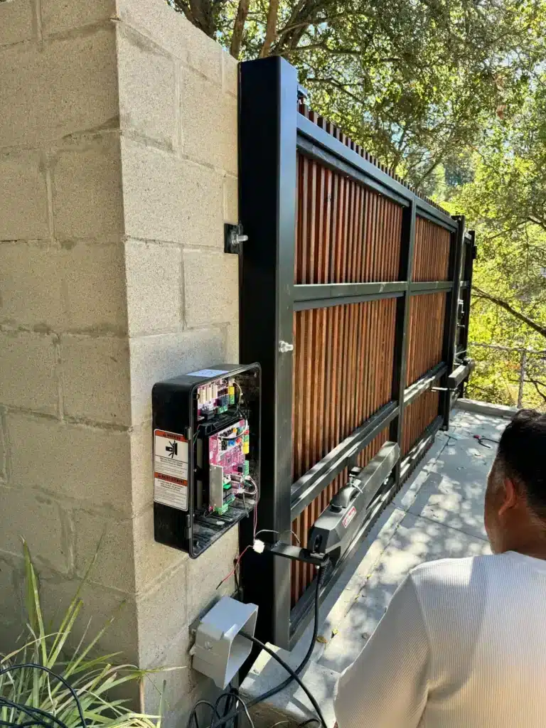 Photo Of Open Electric Gate Opener Control Box Wiring Installed On Modern Wood Gate